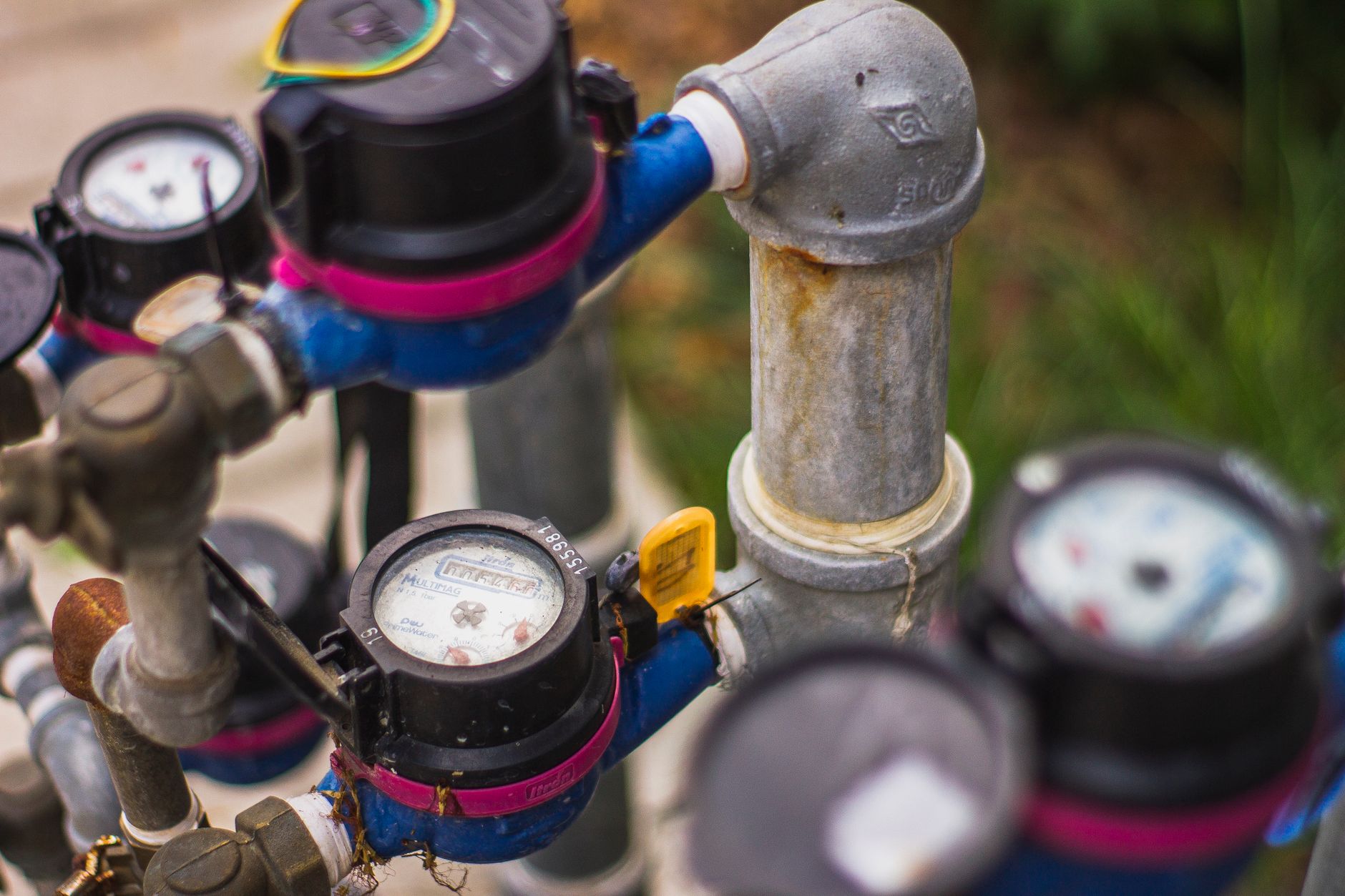 Industrial water pressure gauges and pipes in an outdoor setting