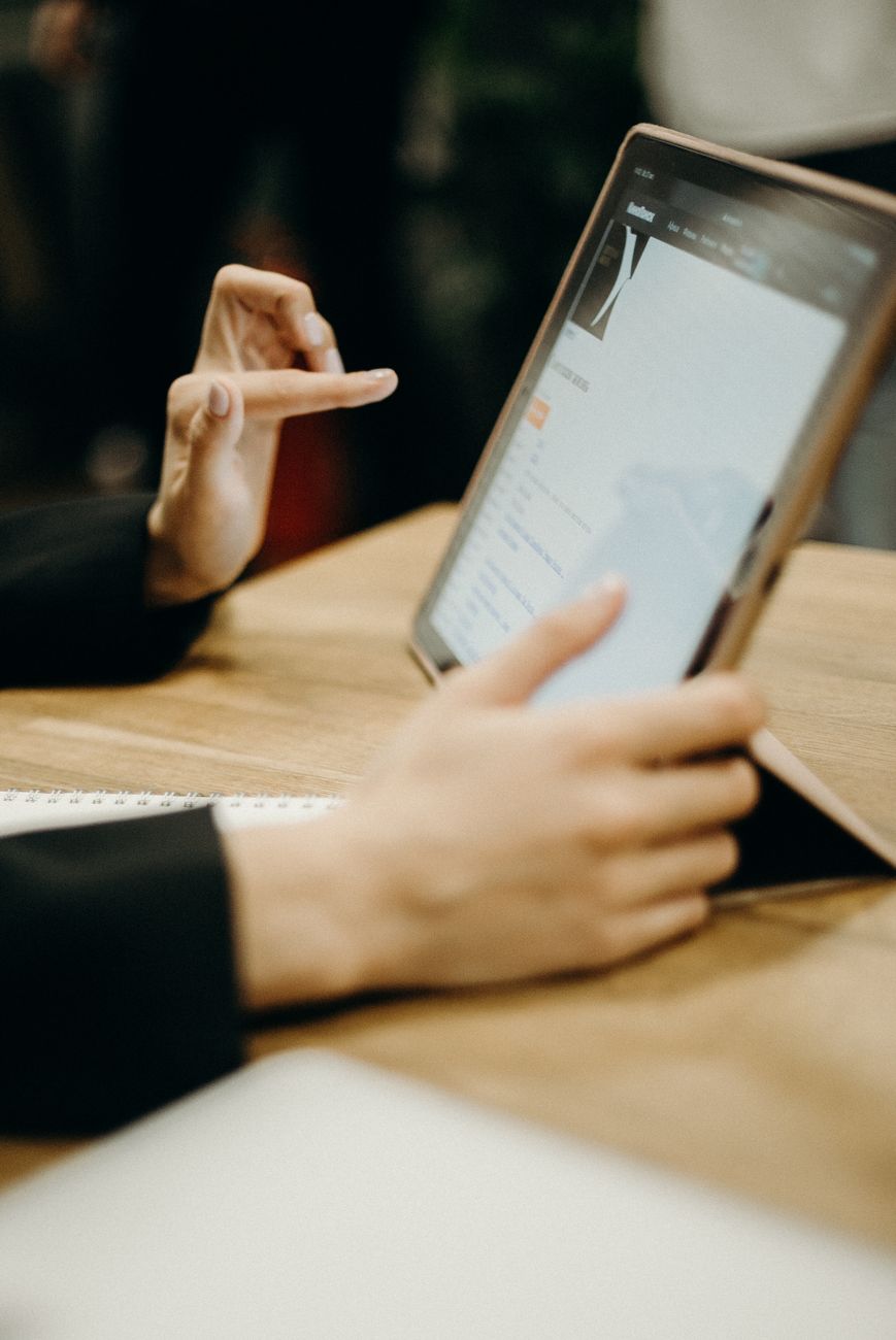 Hands using a tablet during work in a modern office